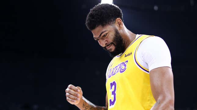 Pictured: Los Angeles Lakers star Anthony Davis looking down at the roof of a two-story building, just out of frame