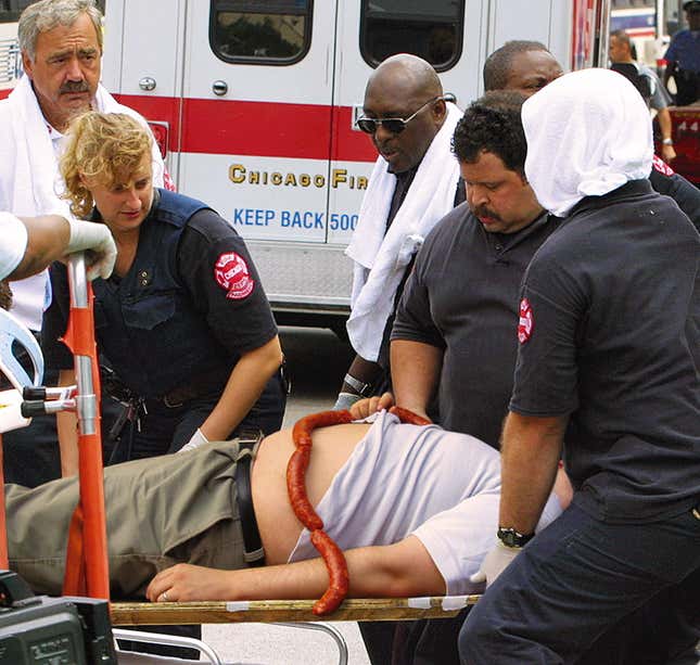 Paramedics administer first aid to a man who collapsed from smoked-sausage inhalation.