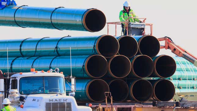 In this May 9, 2015, file photo, workers unload pipes for the proposed Dakota Access oil pipeline. Now, it’s operating, but developers want to push more oil through.