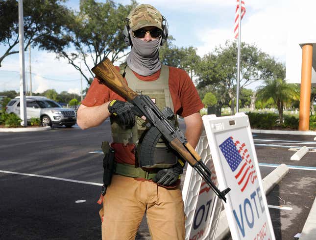 Image for article titled Man Standing Outside Polls With AK-47 Just There To Protect People From Voting