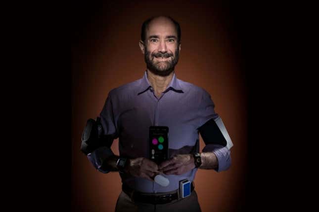 Michael Snyder, director of genomics and personalized medicine at Stanford, straps on a lot of wearables in his hunt to see if they can help detect infectious diseases early.