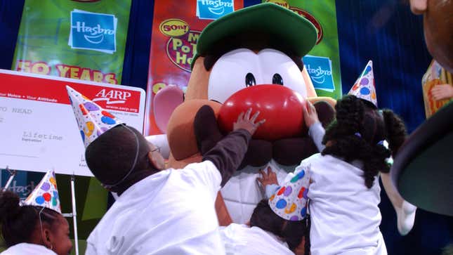 Children reach out to touch Mr. Potato Head as he stands on stage February 5, 2002, at a 50th birthday party for the popular children’s toy at Hasbros showroom in New York City. 