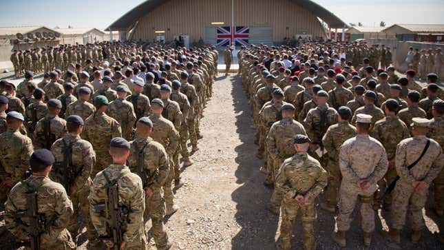 British troops and service personal remaining in Afghanistan are joined by International Security Assistance Force (ISAF) personnel and civilians as they gather for a Remembrance Sunday service at Kandahar Airfield November 9, 2014 in Kandahar, Afghanistan.