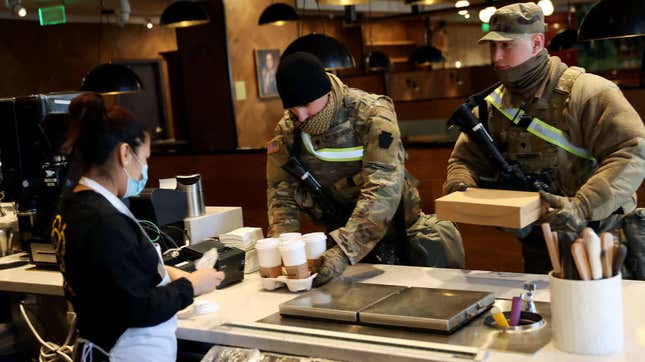 armed national guard members getting coffee