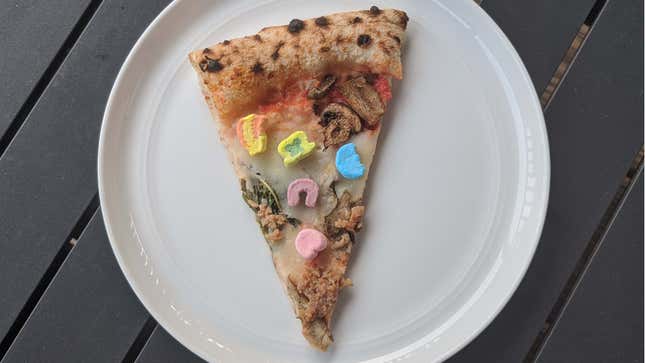 Slice of pizza sprinkled with cereal marshmallows on a white plate