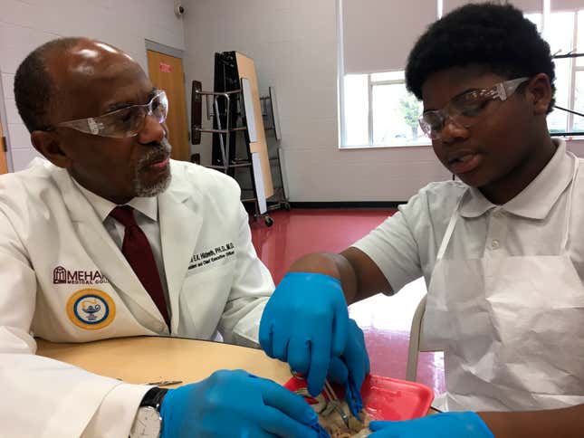 Dr. James Hildreth dissects a frog Friday, March 29, 2019, with seventh-grader Keyshawn Walker at the Haynes Middle Health/Medical Science Design Center in Nashville, Tenn. Hildreth is president and CEO of Nashville’s Meharry Medical College, the nation’s oldest historically black medical school. 