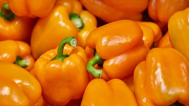 Pile of bright orange bell peppers