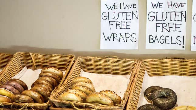 Bagels in baskets with signs reading "we have gluten free wraps and bagels"
