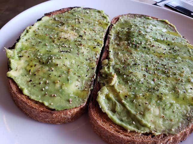 A rustic wheat bread, mashed avocado, olive oil, salt and pepper aka breakfast masterpiece