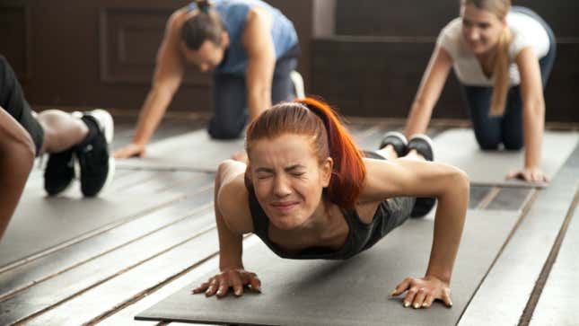 woman struggling to do a pushup