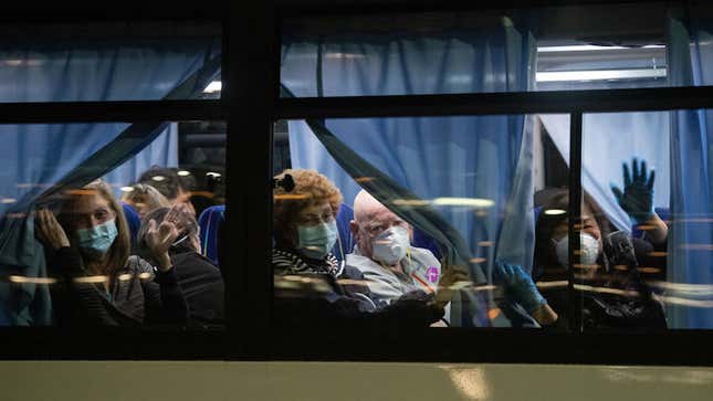 The U.S. reported its first death from coronavirus on Saturday. In this photo, American citizens look out the window as they’re evacuated from the quarantined Diamond Princess cruise ship.