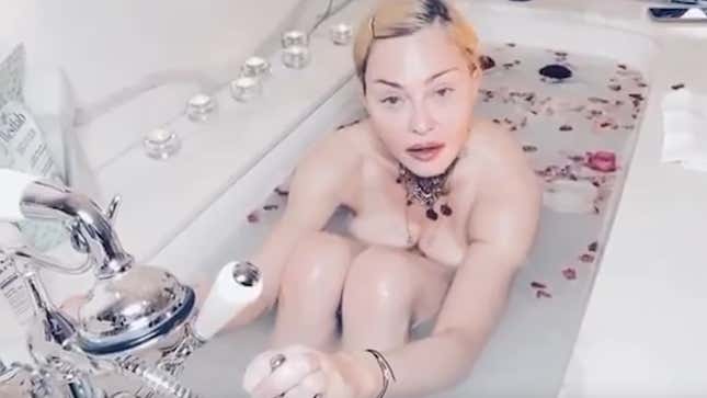 Image for article titled Madonna deletes post calling coronavirus a &quot;great equalizer&quot; from bathtub filled with rose petals