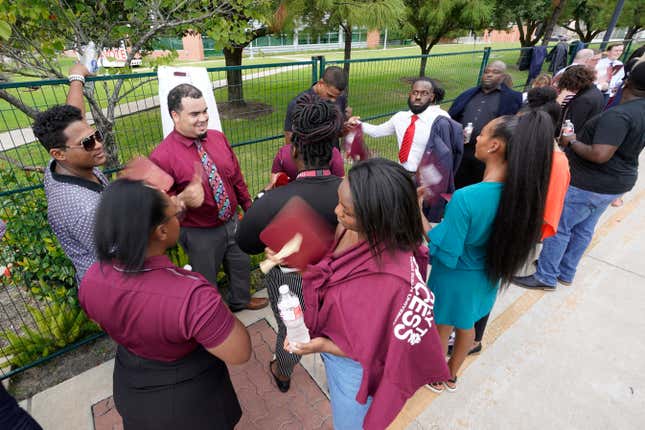 Texas Southern University students wait in the heat to enter a Democratic presidential primary debate hosted by ABC Thursday, Sept. 12, 2019, at Texas Southern University in Houston. 