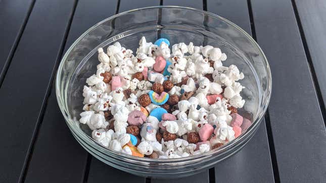 Bowl of popcorn with cereal marshmallows and Cocoa Puffs and chocolate graham pretzels sprinkled in