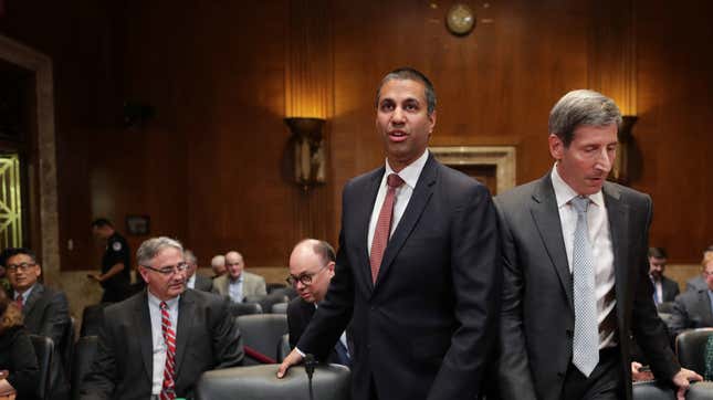FCC Chairman Ajit Pai (L) and FTC Chairman Joseph Simons prepare to testify before the Senate Financial Services and General Government Subcommittee in the Dirksen Senate Office Building on Capitol Hill May 07, 2019 in Washington, DC.