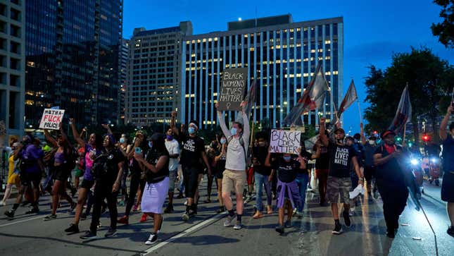Protesters march down the streets during a rally in remembrance of Sandra Bland on July 13, 2020, in Dallas, Texas. e caption
