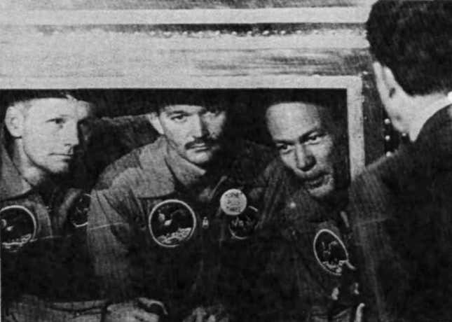 The first astronauts on the Moon sit in isolation while talking to President Richard Nixon