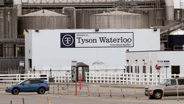 In this May 1, 2020, file photo, vehicles sit in a near empty parking lot outside the Tyson Foods plant in Waterloo, Iowa.