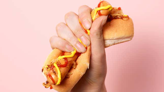 hand gripping hot dog forcefully