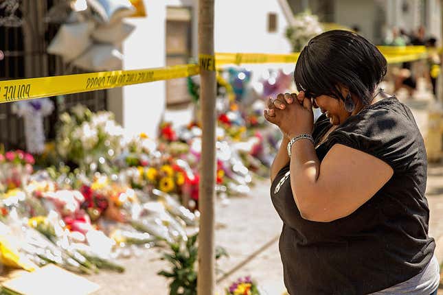 A woman weeps outside historic Mother Emanuel African Methodist Episcopal Church, June 19, 2015, in Charleston, S.C., after Dylann Roof, murdered nine people there during a prayer meeting. Now, survivors and families of the victims are asking a court to allow them to sue the federal government over what they say was a failed background check of Roof, allowing him to get the gun used in the shooting.