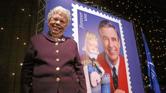 Fred Rogers wife, Mrs. Joanne Rogers poses in front a poster of the Mister Rogers Forever Stamp following the first-day-of-issue dedication in WQED’s Fred Rogers Studio in Pittsburgh, Friday, March 23, 2018