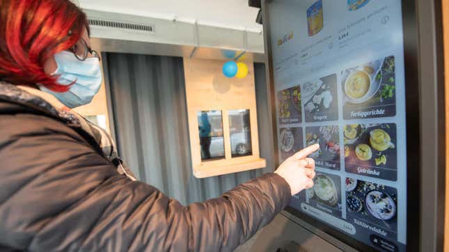 A shopper placing an order at an automated supermarket without employees in Germany