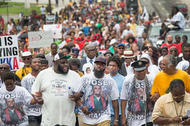 hael Brown Sr. (C-front) leads a march from the location where his son Michael Brown Jr. was shot and killed following a memorial service marking the anniversary of his death on August 9, 2015 in Ferguson, Missouri. 