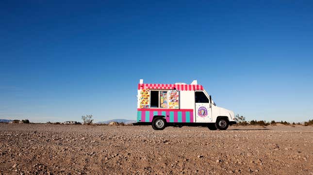 Small food truck crossing desert horizon