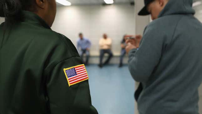 U.S. Immigration and Customs Enforcement (ICE) officers watch over detainees at a facility in Manhattan.
