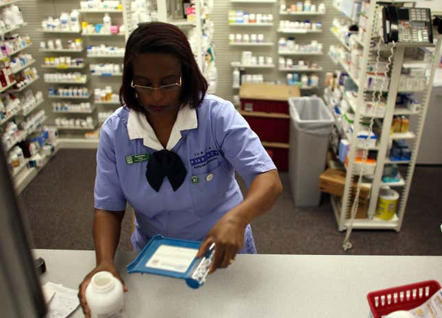 Rosemary Petty, a Publix Supermarket pharmacy technician, counts out a prescription of antibiotic pills August 7, 2007 in Miami, Florida.