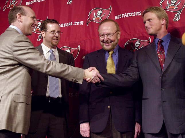 L. to r., Joel, Bryan and their late father Malcolm Glazer introduce Jon Gruden in 2002.