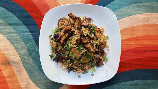 Air Fried Harissa Mushrooms with Toasted Couscous on white plate against colorful background