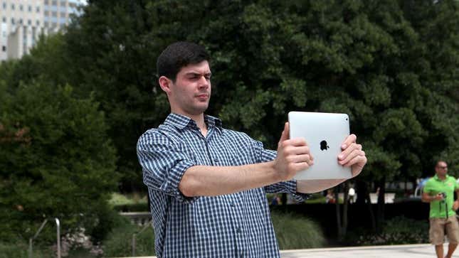 Image for article titled Man Taking Photo With iPad Oblivious To How Badass He Looks