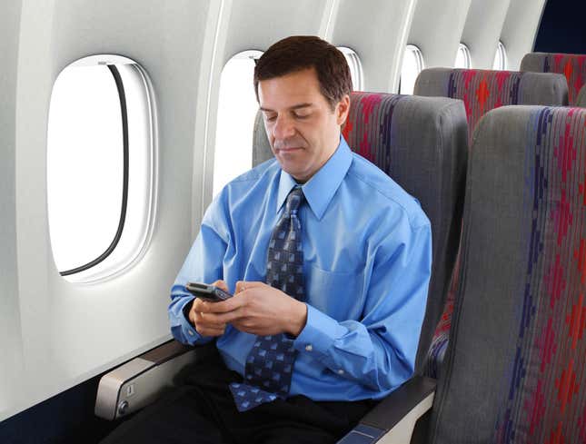Image for article titled Cranky Businessman Quieted For Entire Trip With Brightly Colored Cell Phone Game