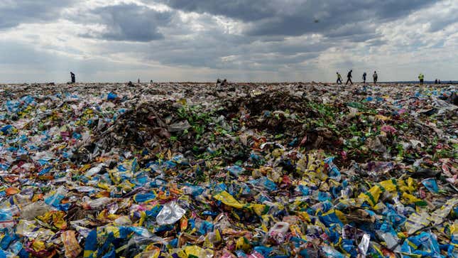 Recyclers scan a landfill in Zimbabwe.