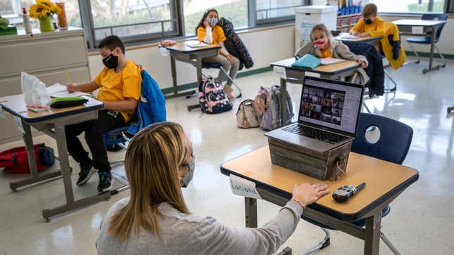  Third grade teacher Cara Denison speaks to students while live streaming her class via Google Meet at Rogers International School on November 19, 2020 in Stamford, Connecticut.
