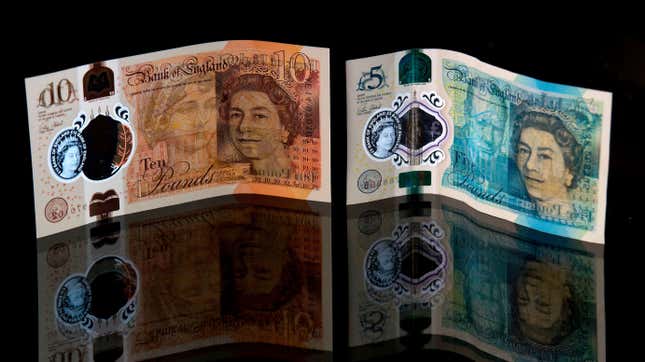 A British ten pound sterling and five pound sterling note are arranged in a photograph in London.