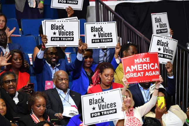 Herman Cain, left center, and supporters of “Black Voices for Trump” listen to him speak during a campaign rally at the BOK Center on June 20, 2020, in Tulsa, Oklahoma.