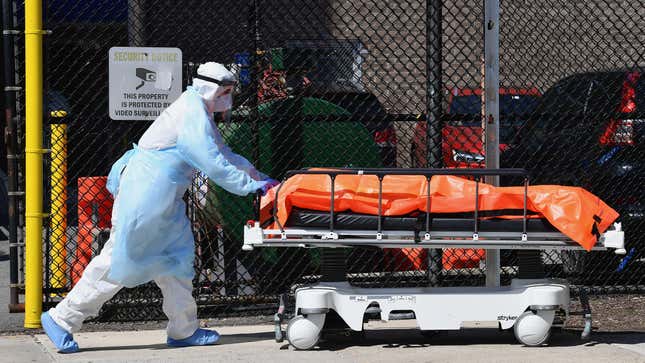 Medical staff move bodies from the Wyckoff Heights Medical Center to a refrigerated truck on April 2, 2020 in Brooklyn, New York. 