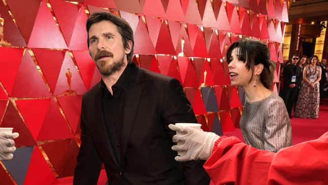 Image for article titled Sweating, Exhausted Christian Bale Stumbles Past 13-Mile Marker On Oscars Red Carpet