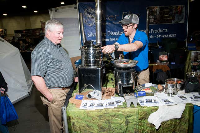 SilverFire vendor specializing in off-grid stoves, “biomass grills” and solar cookers at PrepperCon. Photo: Russel Daniels for Gizmodo