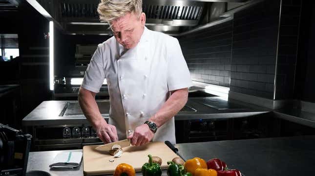 Gordon Ramsay chops vegetables on a cutting board