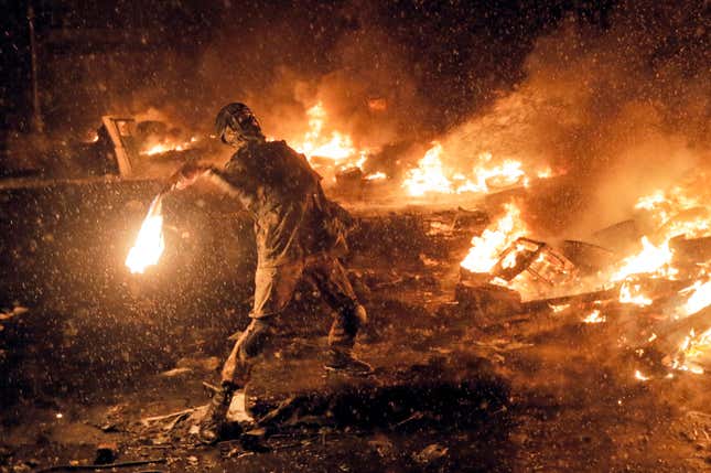 In this Wednesday, Jan. 22, 2014 file photo a protester throws a Molotov cocktail during clashes with police in central Kiev, Ukraine.