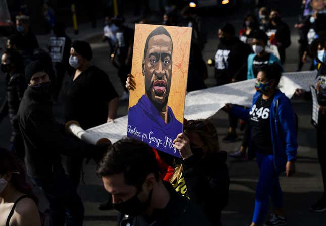 Demonstrators carry a scroll listing the names of people killed by police during a march in honor of George Floyd on March 7, 2021 in Minneapolis, Minnesota. 