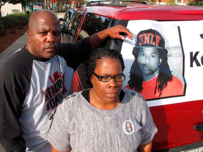 Kenneth and Jacquelyn Johnson stand next to a banner on their SUV showing their late son, Kendrick Johnson in Valdosta, Ga. 
