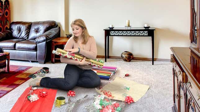 Image for article titled Mom Gathers Rolls Of Wrapping Paper Around Her To Stroke Softly