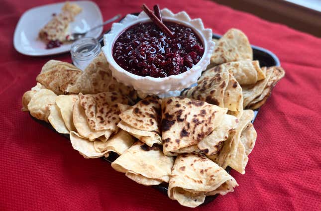 Pile of folded Lefse on plate with bowl of Cranberry-Lingonberry Preserves