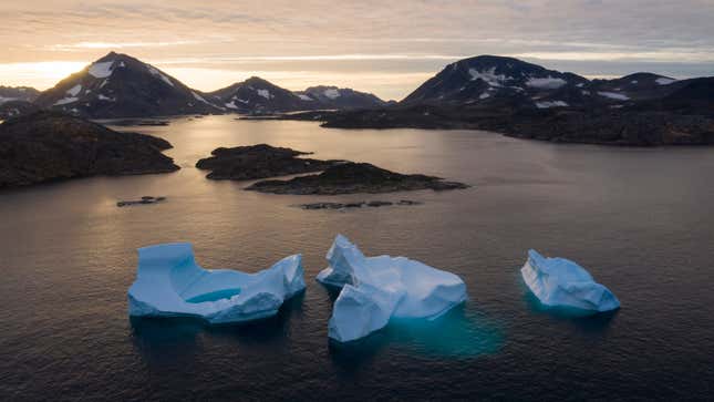 Icebergs float away as the sun rises near Kulusuk, Greenland in August 2019.