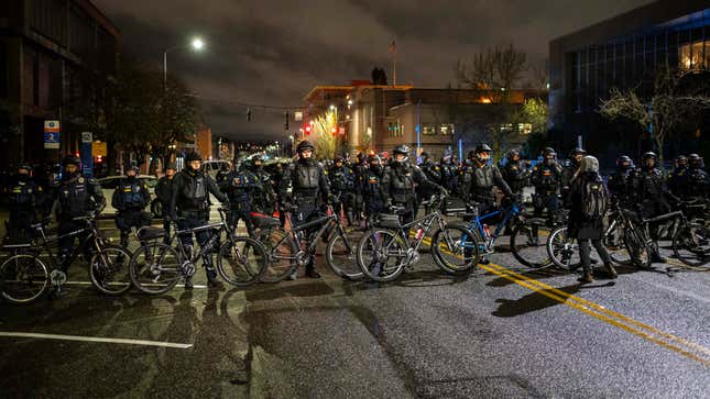 Police and Washington State Troopers block protesters from passing during an anti-police protest on January 24, 2021 in Tacoma, Washington. The previous day, a Tacoma police officer drove their vehicle through a crowd, spurring outrage and triggering an investigation.