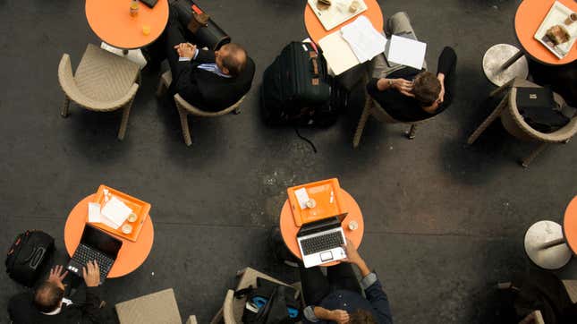 Customers and laptops in a coffee shop